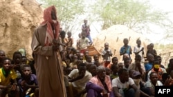 FILE - Residents of a village in the Tillabéri region of Niger attend a meeting May 12, 2020, days after an attack by armed men. On March 16, 2021, another attack on civilians in the area left at least 58 people dead. (Photo by BOUREIMA HAMA /AFP)