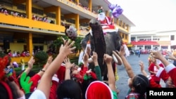 Elephants in Santa Claus costumes visit a school in Ayutthaya
