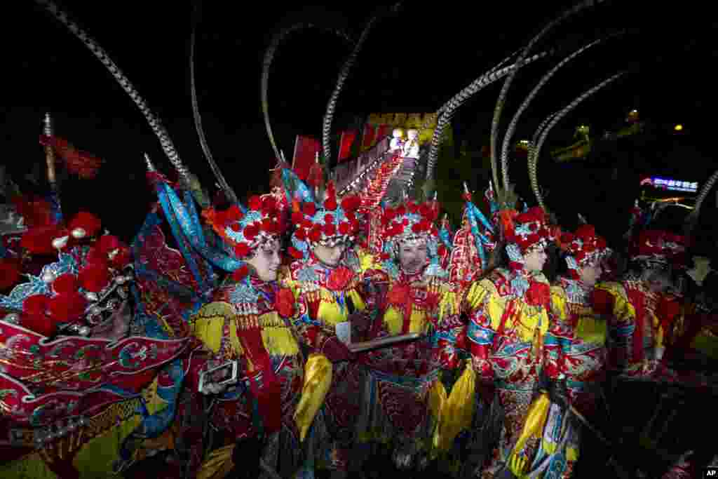 Performers gather for a group photo after the end of a New Year's Eve countdown to 2014, Beijing, China, Jan. 1, 2014. 