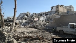 The aftermath of an explosion in Al-Salam Square in Kobani carried out by ISIS using a truck rigged with explosives, Oct. 22, 2014. 