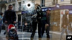 A bullet hole is seen on the window of a cafe located near the area where the assailant of a knife attack was shot dead by police officers, in central Paris, France, May 13, 2018. 