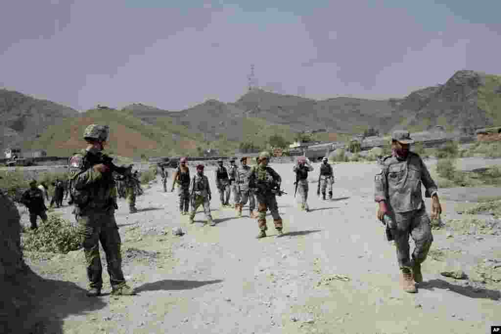 U.S. forces patrol near the scene of an attack by militants on a U.S. base in Torkham, Afghanistan, Sept. 2, 2013.