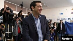 Opposition leader and head of radical leftist Syriza party Alexis Tsipras smiles before casting his ballot at a polling station in Athens, Greece, Jan. 25, 2015. 