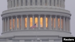 FILE - A United States flag flies in front of the U.S. Capitol dome in Washington, Nov. 6, 2018.