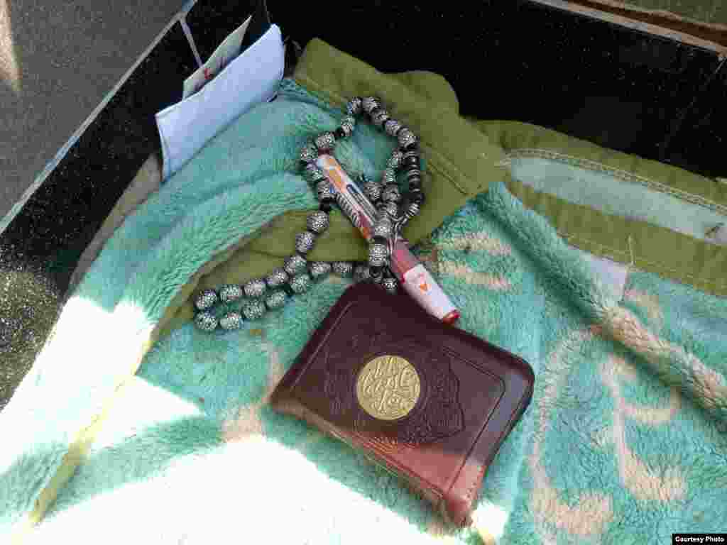 Quran, beads and pen at Muslim Brotherhood rally site outside Rabaa al-Adawiya mosque, Cairo, July 11. Photo: VOA/Sharon Behn