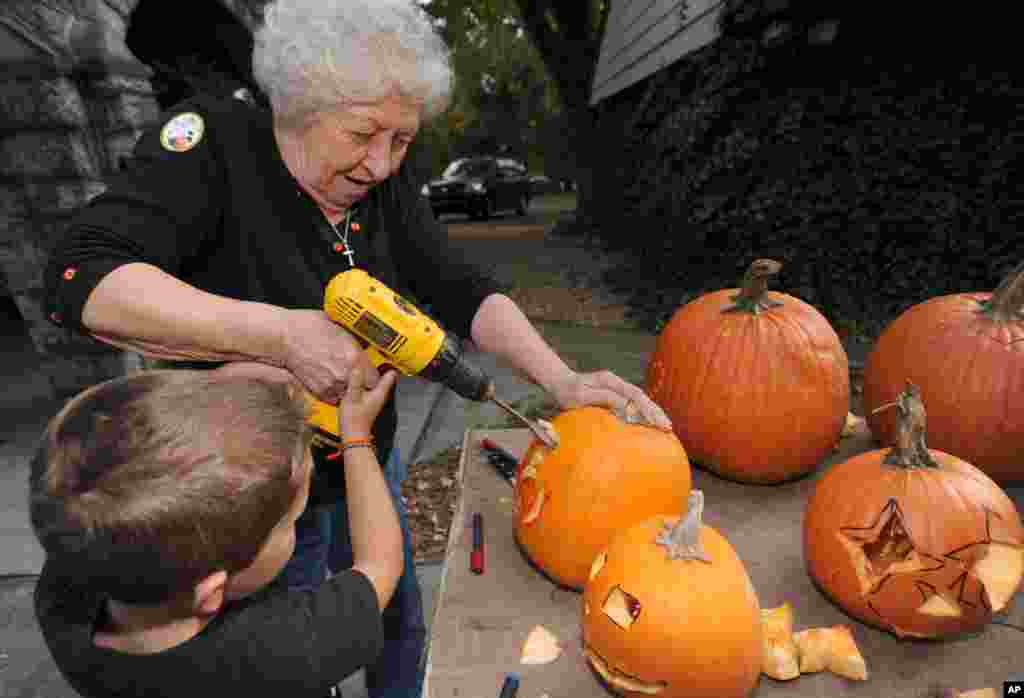 Betty Dillow helps her grandson with his pumpkin carving in Bristol, Virginia.