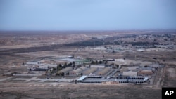 FILE - An aerial photo taken from a helicopter shows Ain al-Asad air base in the western Anbar desert, Iraq, Dec. 29, 2019.