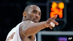 In this June 7, 2009 file photo Los Angeles Lakers guard Kobe Bryant (24) points to a player behind him after making a basket in Game 2 of the NBA basketball finals in Los Angeles. (AP Photo/Mark J. Terrill)