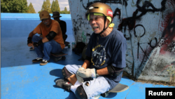 Yoshio Kinoshita takes a break during his skateboarding practice at a park in Daito, Osaka Prefecture, Japan October 6, 2021. (REUTERS/Akira Tomoshige)