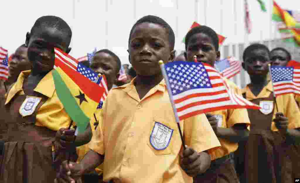 Children waves American and Ghana flags during an arrival ceremony for First lady Melania Trump at Kotoka International Airport in Accra, Ghana, Oct. 2, 2018.