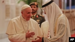 Pope Francis is welcomed by Abu Dhabi's Crown Prince Sheikh Mohammed bin Zayed Al Nahyan, upon his arrival at the Abu Dhabi airport, United Arab Emirates, Sunday, Feb. 3, 2019.