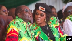 FILE - Zimbabwean President Robert Mugabe and his wife Grace follow proceedings during a youth rally in Marondera about 100 kilometers east of Harare, June, 2, 2017.