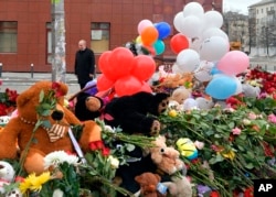 Russian President Vladimir Putin visits a memorial made for the victims of a fire in a multi-story shopping center in the Siberian city of Kemerovo, about 3,000 kilometers (1,900 miles) east of Moscow, Russia, March 27, 2018.