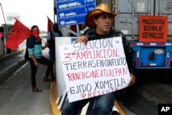 FILE - Atenco residents protest the construction of the new Mexico City airport near their community, near Texcoco, Mexico, Oct. 12, 2018.