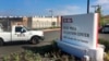 FILE - A vehicle drives into the Otay Mesa Detention Center in San Diego, California. Authorities say a 57-year-old person in immigration custody has died from complications related to the coronavirus.