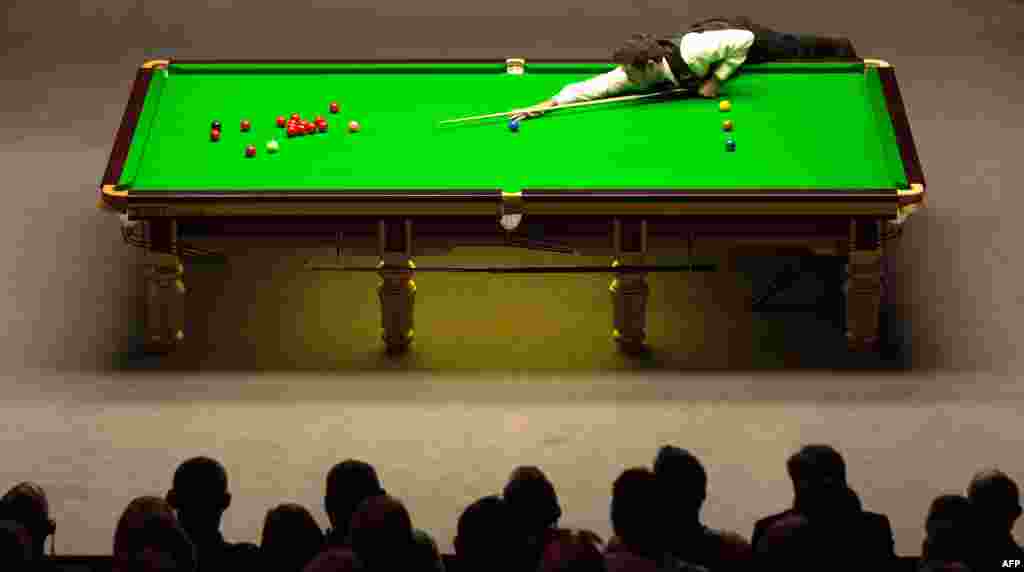 Ronnie O'Sullivan of England plays a shot during the World Snooker Championship 2014 final against Mark Selby of England at The Crucible in Sheffield, England.