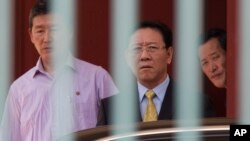 North Korean Ambassador to Malaysia, Kang Chol, center, prepares to get in a car at the embassy in Kuala Lumpur, Malaysia, March 6, 2017. Malaysia is expelling Chol over the poisoning of Kim Jong Nam, the estranged half-brother of North Korea's leader.