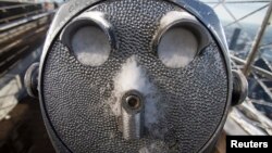 A coin-operated binoculars' eye holes are full of snow on the roof of Empire State Building in the Manhattan borough of New York, Feb. 14, 2014.