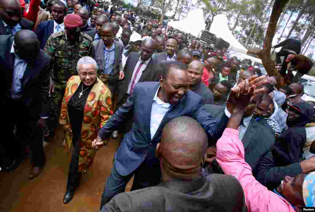 Kenya's President Uhuru Kenyatta is greeted by supporters after casting his vote in the Kenya election in his hometown of Gatundu in Kiambu county, Kenya, Aug. 8, 2017.