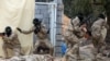 Libyan security forces trained by the Turkish military demonstrate their skills during a graduation ceremony in Khums, Libya, April 8, 2021. 