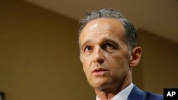 FILE - German Foreign Minister Heiko Maas, speaks to the media after a meeting on the migrant issue in Paris, France, July 22, 2109.