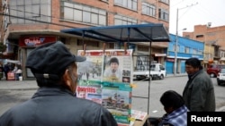 FILE - A man looks at newspapers, following Bolivia's former president Evo Morales' exit out of the country, in La Paz, Bolivia, Nov. 12, 2019.