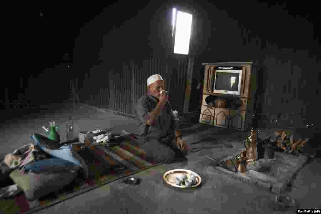In this Wednesday, Oct. 12, 2011 photo an Israeli Bedouin man drinks coffee in his village near the southern city of Beersheva,Israel.