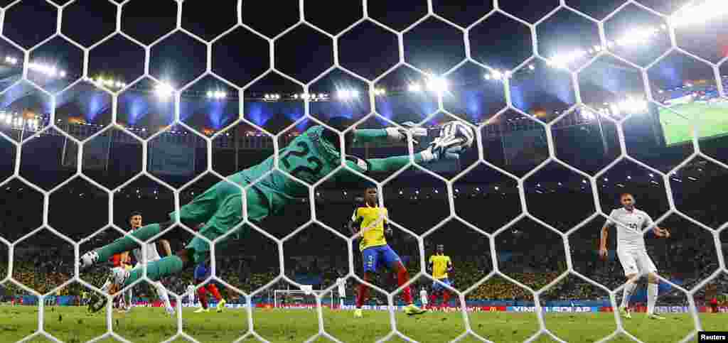 Ecuadorian goalkeeper Alexander Dominguez keeps the game close with this remarkable save against France at the Maracana stadium, in Rio de Janeiro, June 25, 2014.