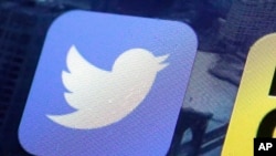 FILE - This Oct. 18, 2013, file photo, shows a Twitter app on an iPhone screen in New York. Twitter vowed to crack down further on hate speech and sexual harassment on its platform, days after CEO Jack Dorsey said in a tweet-storm on Oct. 18, 2017, that the company was "still" not doing enough to protect its users. 