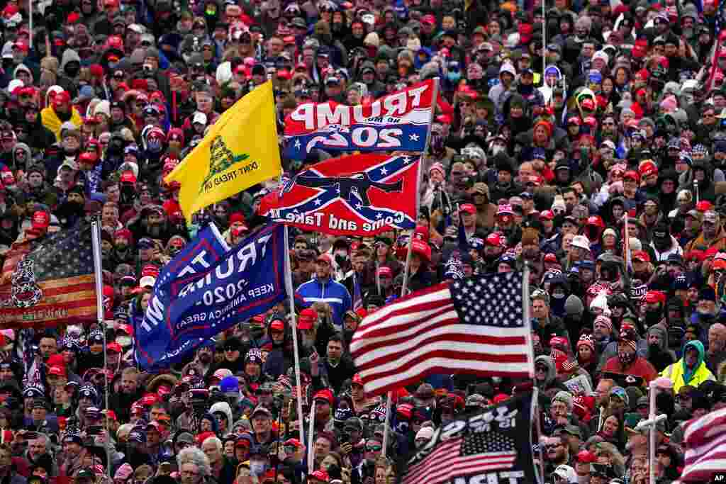 People listen as President Donald Trump speaks during a rally, Jan. 6, 2021, in Washington.
