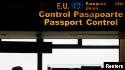 FILE - A man is seen walking in the passport control area at Bucharest's Henri Coanda International Airport.