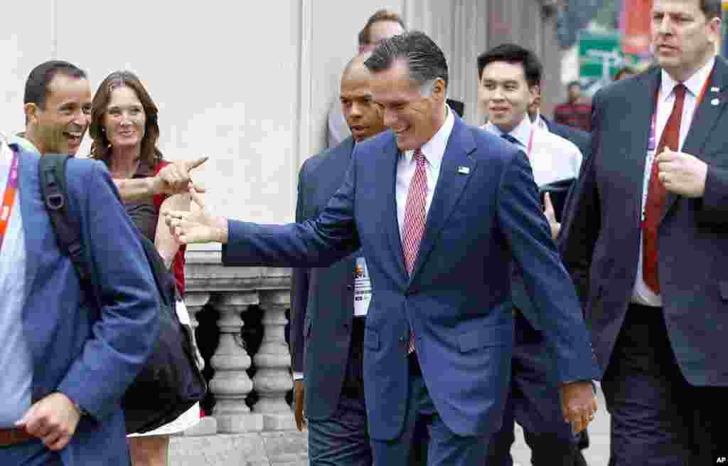 Romney walks down Grosvenor Place to avoid a traffic jam and is recognized by bystanders. He was walking to meet Ireland's Prime Minister Enda Kenny at the Embassy of Ireland in London, July 27, 2012.