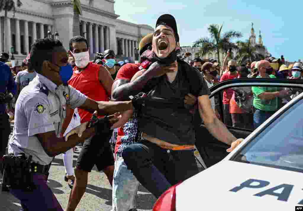 A person is arrested during a demonstration against the government of Cuban President Miguel Diaz-Canel in Havana, July 11, 2021.