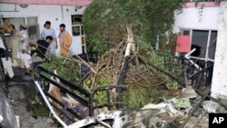 FILE - Afghans inspect damage to the Ahmadi family house after a U.S. drone strike in Kabul, Afghanistan, Aug. 29, 2021.