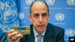 Tomas Ojea Quintana, the United Nations special investigator on human rights in North Korea, holds up a lock given to him by North Koreans who escaped from the country, during a press conference, Oct. 23, 2018, at U.N. headquarters in New York.
