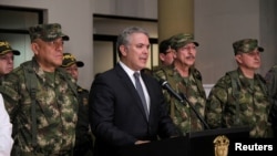 Colombia’s President Ivan Duque speaks next to commanders of military forces in Popayan, Sept. 12, 2019. 