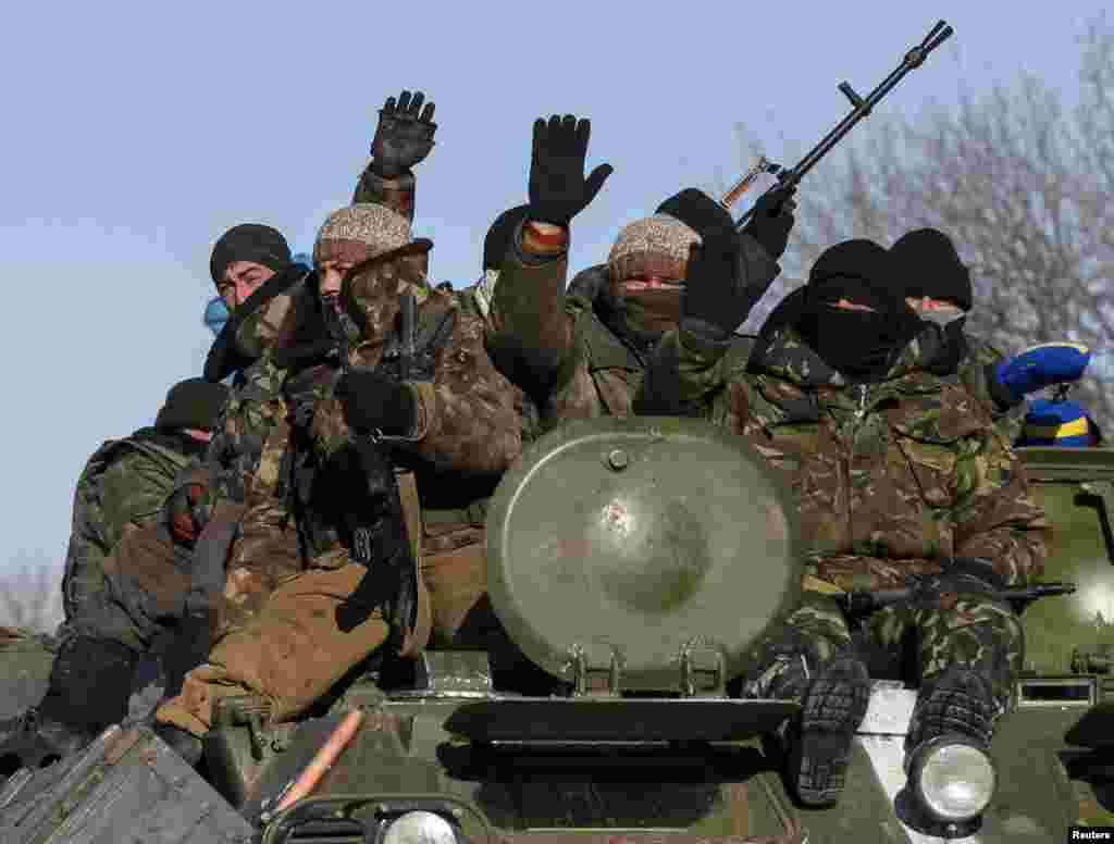 Members of the Ukrainian armed forces ride on a military vehicle near Debaltseve, eastern Ukraine, Feb. 17, 2015.