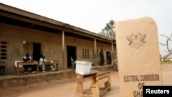 FILE - A sign for Ghana's Electoral Commission is seen at a polling station in Accra, Jan. 2, 2009.