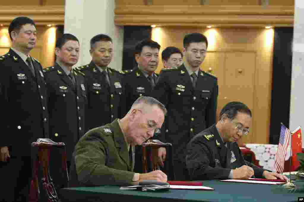 美军参联会主席邓福德上将(前左)与中国中央军委联合参谋部参谋长房峰辉在北京签署协议(2017年8月15日)。美国和中国高级军事将领在朝鲜导弹项目和中国在南中国海有争议申索造成局势紧张之际签署了加强两军通讯交流的协议。