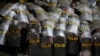 Para petugas polisi tampak melindungi diri mereka dengan tameng ketika melakukan pengamanan dalam aksi unjuk rasa penentangan terhadap Undang-undang Omnibus di Jakarta, pada 13 Oktober 2020. (Foto: Reuters/Willy Kurniawan)
