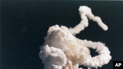 The space shuttle Challenger explodes 73 seconds after takeoff on Jan. 28, 1986, at Kennedy Space Center, Florida. This picture shows the main engine exhaust, solid rocket booster plume and an expanding ball of gas from the external tank, visible seconds