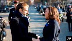 French President Emmanuel Macron speaks to Vice President Kamala Harris before ceremonies marking the 103rd anniversary of Armistice Day, Nov. 11, 2021 in Paris. 