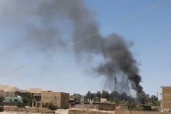 Una columna de humo se eleva en medio de los continuos combates entre las fuerzas de seguridad afganas y los insurgentes talibanes en la ciudad occidental de Qala-e-Naw, capital de la provincia de Badghis en Afganistán, el 7 de julio de 2021.