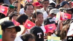 Para peserta rapat akbar mengusung bendera nasional dan militer dalam acara upacara baris berbaris yang mendukung pegawai negeri sipil dan militer hari Minggu, 29 Oktober 2017 di Yangon, Myanmar (foto: AP Photo/Thein Zaw)