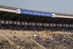 Members of the public sit in the stands during the state funeral for former president Robert Mugabe, at the National Sports Stadium, in the capital Harare, Zimbabwe, Sept. 14, 2019.