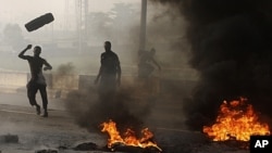 Matasa a fusace su na kona tayoyi da tarkace domin su nuna rashin yardarsu da janye tallafin farashin mai da gwamnatin shugaba Goodluck Jonathan ta yi, Lagos Talata, 10 Janairu 2012.