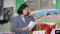 Taiwanese President Tsai Ing-wen waits to cast her ballot at a polling station, Saturday, Nov. 24, 2018, in Taipei, Taiwan. 