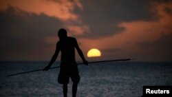 FILE - An Aboriginee is seen spear fishing in Australia's Northern Territory.