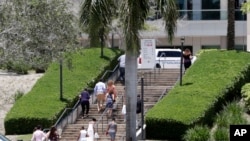 People arrive for a graduation ceremony for Marjory Stoneman Douglas High School seniors, June 3, 2018, in Sunrise, Florida. 