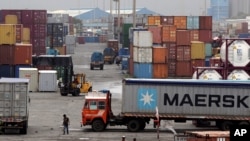 FILE - Containers are piled up at a terminal at the Jawaharlal Nehru Port Trust in Mumbai, India, June 29, 2017. India’s commerce ministry says it will not try to hold onto its preferential zero-tariffs status with the United States.